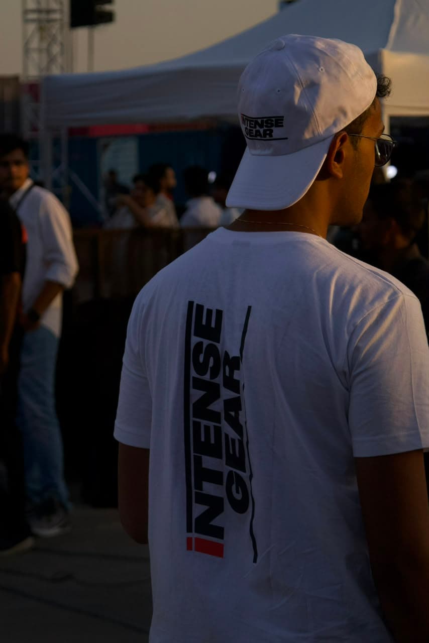 Fan in Intense Gear cap and tee at an event